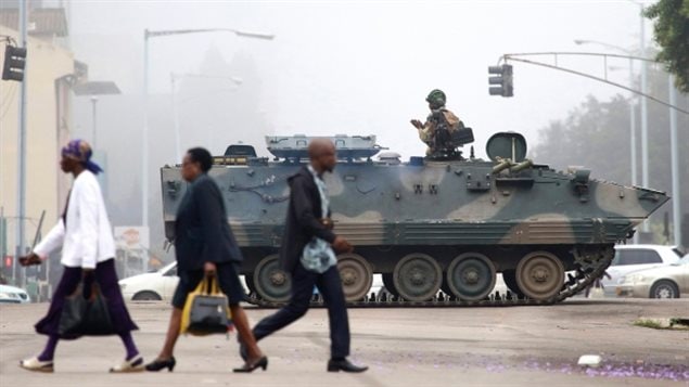 Un carro blindado patrulla una calle en Harare, Zimbabue. Al menos tres explosiones se escucharon  este  miércoles en la capital. 