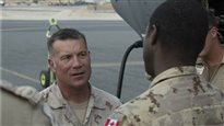 Brigadier-General Daniel MacIsaac, the Commander of Joint Task Forces - Iraq, greets new members of Operation IMPACT as they disembark from a Royal Canadian Air Force CC-130J Hercules on July 7, 2017.