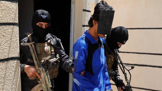 Kurdish soldiers from the Anti-Terrorism Units escort a blindfolded Indonesian man suspected of ISIS membership, at a security centre, in Kobani, Syria in June. Several coalition governments have strongly suggested to anti-Daesh forces that foreign fighters should be killed rather than allow them to return. Canada has a policy of reintegration.