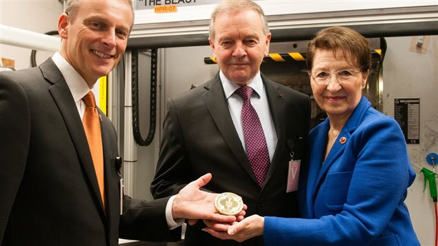 Senators David Wells, Serge Joyal and Betty Unger hold up the first test Senate of Canada Sesquicentennial Medal at the Royal Canadian Mint on June 7, 2017.