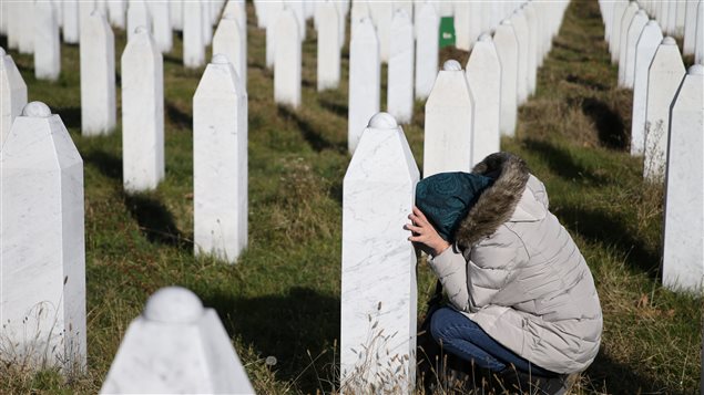 A woman reacts near a grave of her family members in the Memorial centre Potocari near Srebrenica, Bosnia and Herzegovina, after the court proceedings of former Bosnian Serb general Ratko Mladic, November 22, 2017.