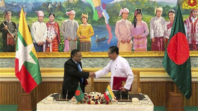 In this image provided by Myanmar’s Ministry of Information, Myanmar’s Union Minister for the Office of the State Counsellor Kyaw Tint Swe, right, shakes hand with Bangladeshi Foreign Minister Abdul Hassan Mahmud Ali after signing the Arrangement on Return of Displaced Persons from Rakhine State in Naypyitaw, Myanmar, Thursday, Nov. 23, 2017. 