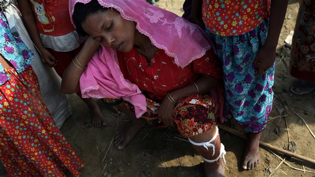 A Rohingya refugee with an injured leg rests exhausted hours after crossing the Bangladesh-Myanmar border at Shah Porir Dwip near Cox’s Bazar, Bangladesh, November 23, 2017.