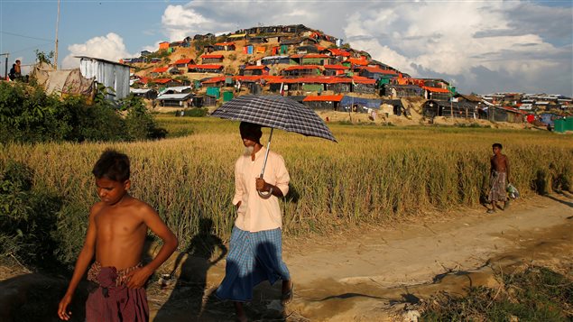 Rohingya refugees walk along the hill covered with temporary shelters at Palong Khali refugee camp, near Cox’s Bazar, Bangladesh, November 14, 2017.