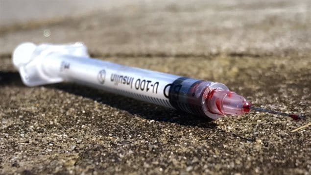 A discarded needle sits on the sidewalk of a Vancouver street. More than 2,800 people died in Canada in 2016 due to opiod related overdoses