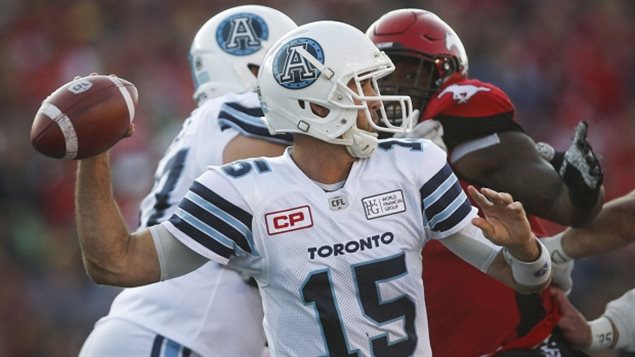 Toronto Argonauts’ quarterback Ricky Ray throws the ball as a Calgary Stampeders closes in during first half CFL football action in Calgary, Saturday, Aug. 26, 2017