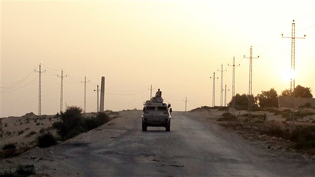 FILE PHOTO: An Egyptian military vehicle is seen on the highway in northern Sinai, Egypt, May 25, 2015.