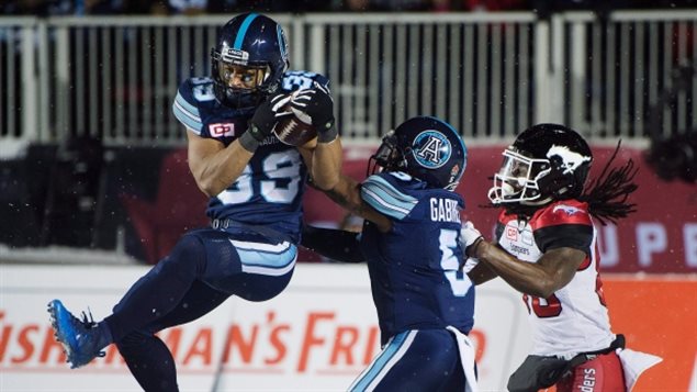 After trailing most of the game, in the final seconds, Toronto defensive back Matt Black, left, intercepts a Calgary pass in the Argo endzone to seal the Argonauts’ Grey Cup victory and dash the Stamps desperate hopes of last moment win. 