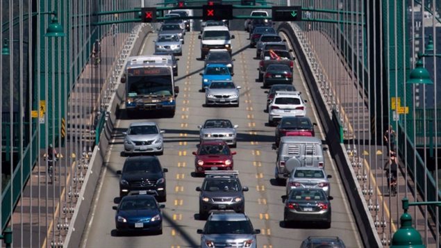 Traffic crosses over the Lions Gate Bridge from North Vancouver into Vancouver, B.C., on Thursday July 2, 2015; Latest data says more Canadians are taking public transit, but commuting is taking longer