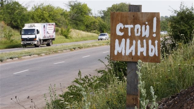 A poster reading ’Stop! Mines!’ stands at a verge near the city of Kramatorsk, Donetsk region, eastern Ukraine Tuesday, June 24, 2014. 