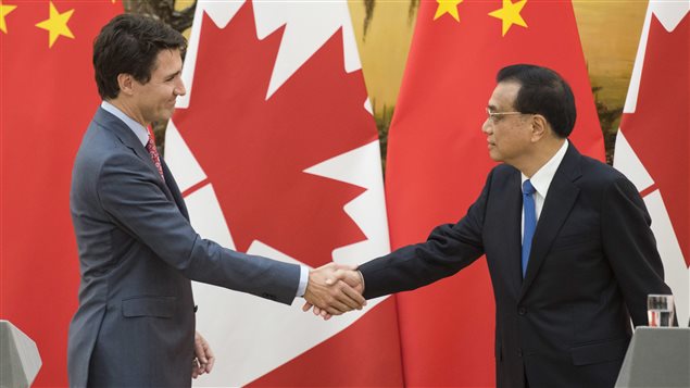 Canadian Prime Minister Justin Trudeau, left, and Chinese Premier Li Keqiang shake hands at the end of a press conference at the Great Hall of the People in Beijing Monday, Dec. 4, 2017.