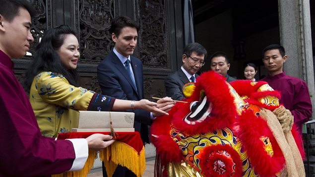 Prime Minister Justin Trudeau takes part in an eye-dotting ceremony to awaken the lion as he is given a tour of the Chen Clan Academy in Guangzhou, China on Thursday, Dec. 7, 2017. 