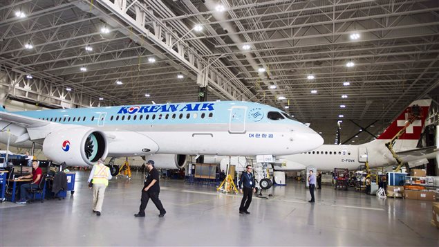 Bombardier employees work on C-series 300 jets at the plant in Mirabel, Quebec on September 28, 2017. Components are also made in Northern Ireland and the U.S.