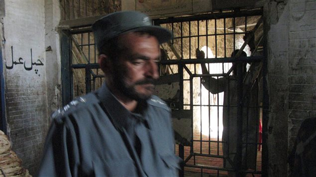 A prisoner leans against the entrance to the wing where political prisoners are kept at Sarposa prison in Kandhar city, in this 2009 file photo.