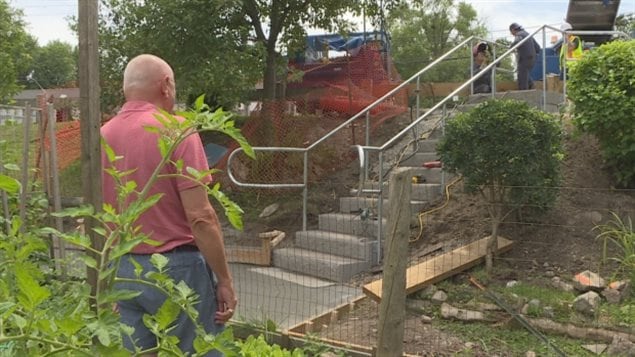 Adi Astl, a 73-year-old retired mechanic, left, who built a homemade staircase for $550 at a steep popular shortcut in a small park, commended the city for quickly addressing the issue with a new set of stairs, which opened in late July