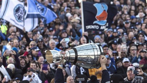 Toronto Argonauts players show off the Grey Cup to fans gathered in Toronto's Nathan Phillips Square as the team holds a Cup winning rally, on Tuesday on Nov. 28. Two days before in Ottawa, the Argos defeated Calgary 27-24. It was Toronto's record 17th championship.
