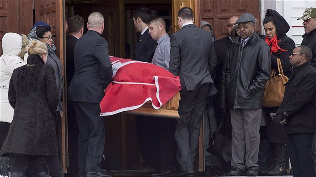 The flag-draped coffin of Lionel Desmond is carried into St. Peter's Church in Tracadie, N.S. on Jan. 11, 2017. 