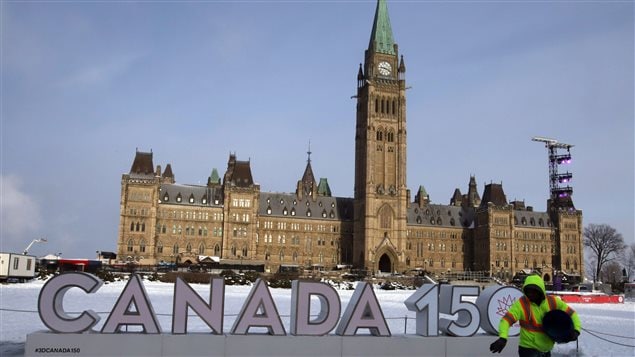 A worker spreads ice melter in front of the Canada 150 sign on Parliament Hill. Heritage Canada was forced to cancel numerous Canada 150 events in Ottawa and elsewhere because of the extreme cold weather conditions currently gripping Canada. 