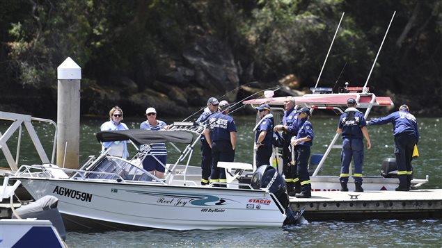 Fire & Rescue NSW personnel are seen at Apple Tree Bay boat ramp, near Bobbin Head, New South Wales, on Tuesday, Jan. 2, 2018. An accident investigator says the wreckage of a seaplane that crashed in a river north of Sydney will be raised this week. But investigators have offered no clues to the cause of the crash that killed the Canadian pilot and his five British passengers.