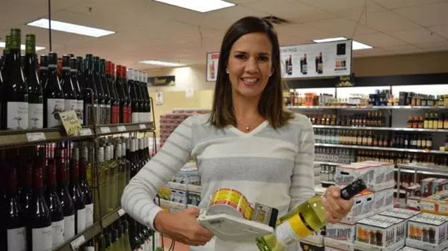 Erin Hobin, one of the leads on the project shown here in 2017 putting labels on wine and spirit bottles in a Whitehorse liquor outlet.