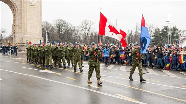 Bucharest, Romania. December 1, 2017 – Air Task Force Romania personnel, on Operation REASSURANCE in support of NATO enhanced Air Policing, march through the Arch of Triumph during the Romanian National Day Parade. 