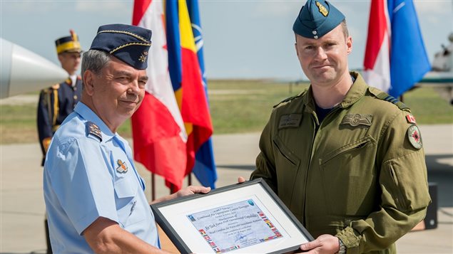 Constanta, Romania. August 31, 2017 – Lieutenant-General Ruben C. Garcia Servert, Commander CAOC Torrejon, presents a NATO certificate to Lieutenant-Colonel Mark Hickey, Air Task Force Romania Commander, during the NATO *Mission Ready* Certification Ceremony at Mihail Kogalniceanu Air Base. 