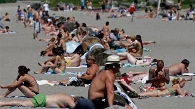 Sunbathers at English Bay, Vancouver. Without the protection of the Earth’s ozone layer, damage to eyes and skin cancer rates would soar.