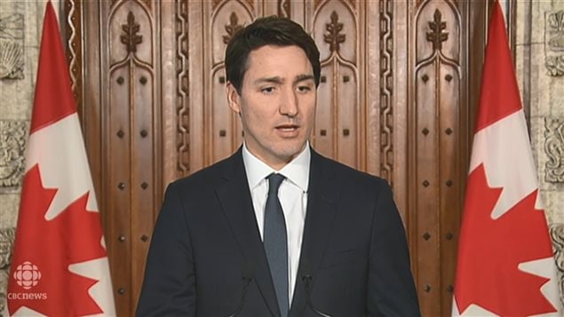 In the Parliament, Prime Minister Justin Trudeau hesitates while answering a question from a CBC reporter about the vacation