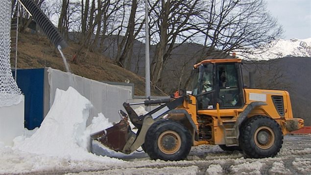 Canadian technology snow making machines were kept busy at Sochi where front-end loader picks up snos to place into dump trucks to take to various skiing events in 2014 in an around the clock operation due to warm weather melting of snow.