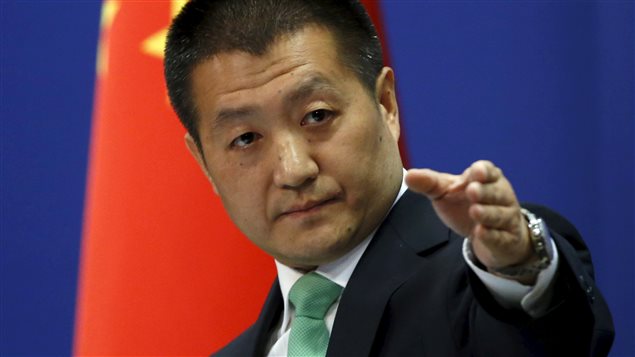 Chinese Foreign Ministry spokesman Lu Kang points out a reporter to receive a question at a regular news conference in Beijing, October 27, 2015.