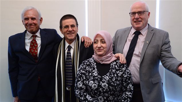 Hassan Diab, second left, and his wife Rania Tfaily, lawyer Don Bayne, left, and Alex Neve, of Amnesty International Canada, stand together in Ottawa on Wednesday. Supporters of Hassan Diab, recently freed by French authorities, want a public inquiry into his extradition on suspicion of murder. 