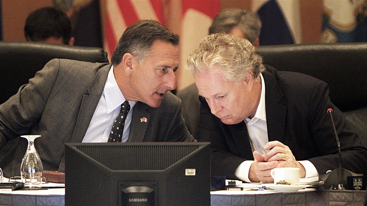 Le gouverneur du Vermont, Peter Shumlin, discute avec le premier ministre québécois, Jean Charest, lors de la rencontre à Burlington, le 30 juillet.