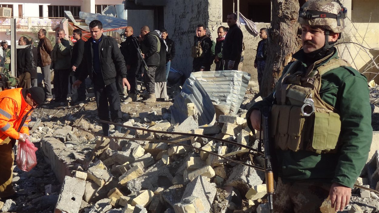 Des Irakiens inspectent les lieux d'un attentat à la voiture piégée survenu à Kirkouk, à 240 km au nord de Bagdad.