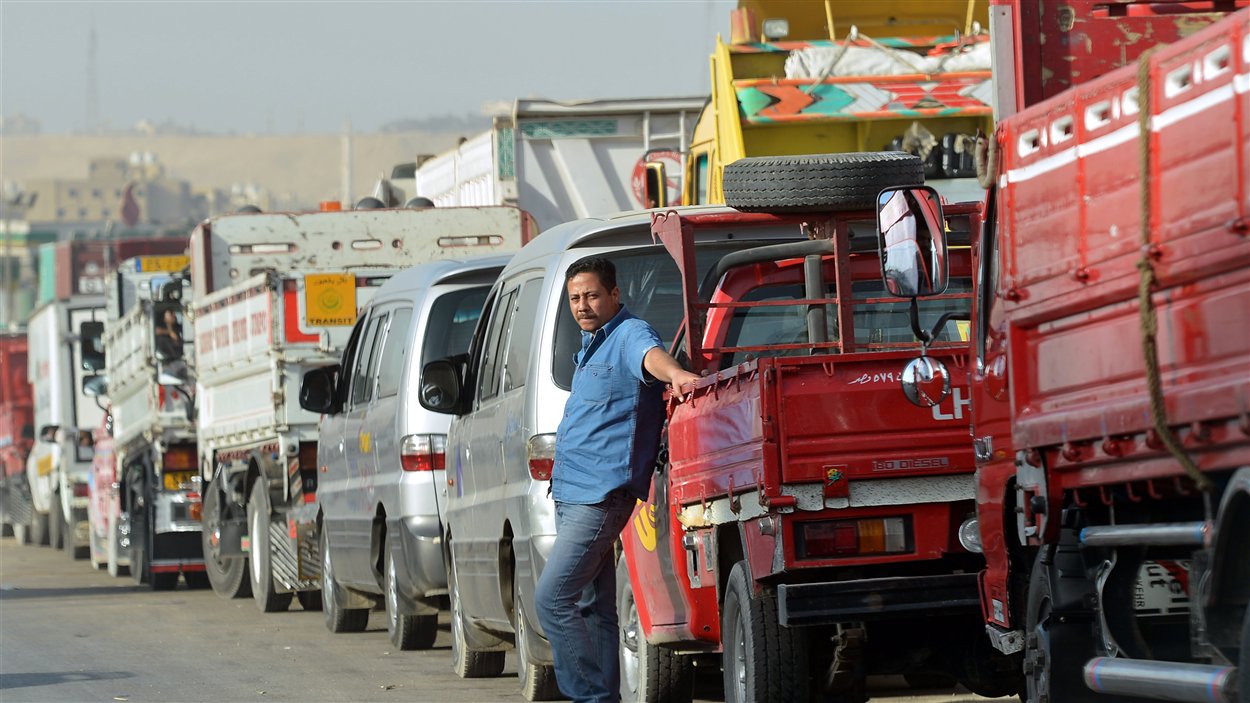 Camion et voitures attendent de faire le plein à une station d'essence du Caire