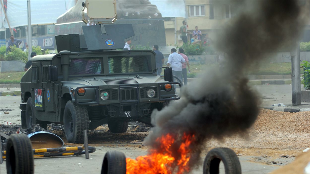 Un véhicule militaire aux abords de la place Ennahda au Caire durant l’opération d’évacuation par la force des partisans du président renversé par l’armée.