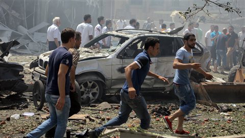 Des citoyens se précipitent sur les lieux de l'une des explosions qui ont secoué Tripoli, dans le nord du Liban.