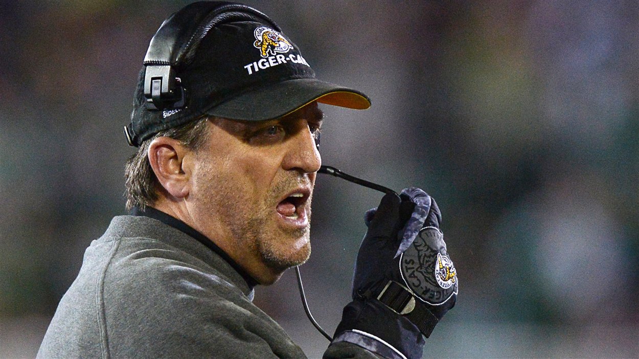 L'entraîneur-chef des Tiger-Cats Kent Austin crie de la ligne de côté pendant le deuxième quart du match de finale de la Coupe Grey contre les Roughriders à Regina.