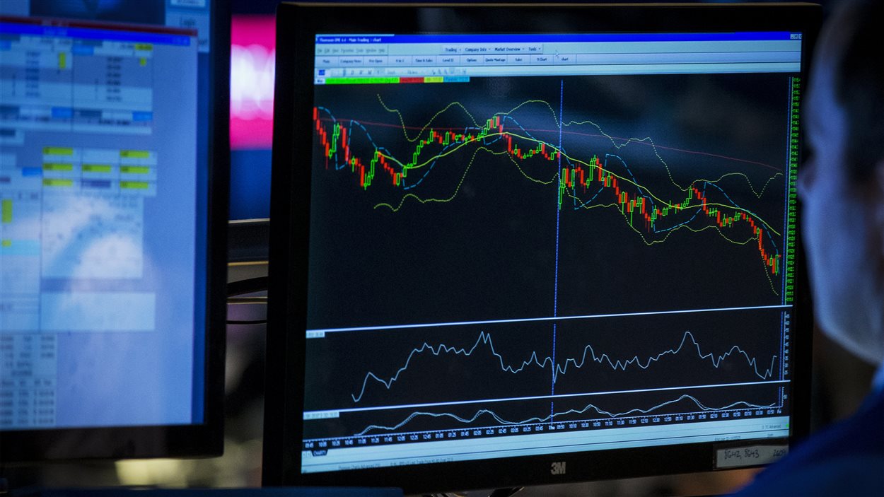 Un courtier regarde son écran à la bourse de New York tandis que les marchés plongent, le 17 juillet 2014