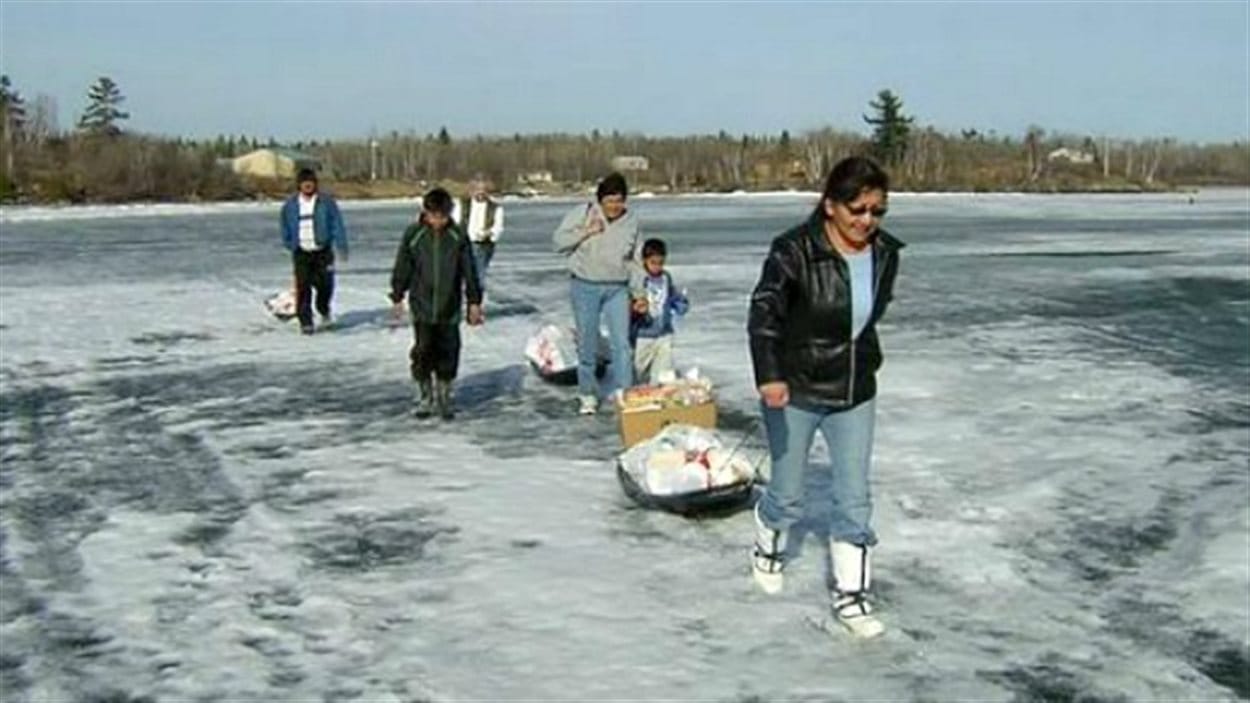 Des membres de la Première Nation Shoal Lake 40 transportant leurs provisions