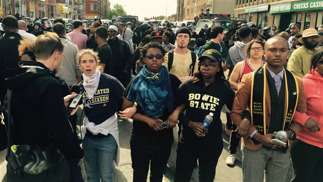 Une chaîne humaine de bénévoles s'est formée entre les manifestants et les policiers à Baltimore, pour éviter tout contact.