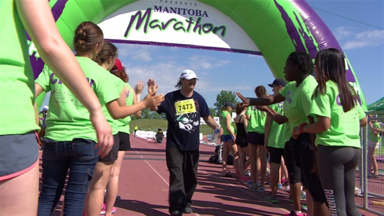 Dwayne Mansell de Flin Flon à la ligne d'arrivée après avoir couru le demi-marathon à Winnipeg.