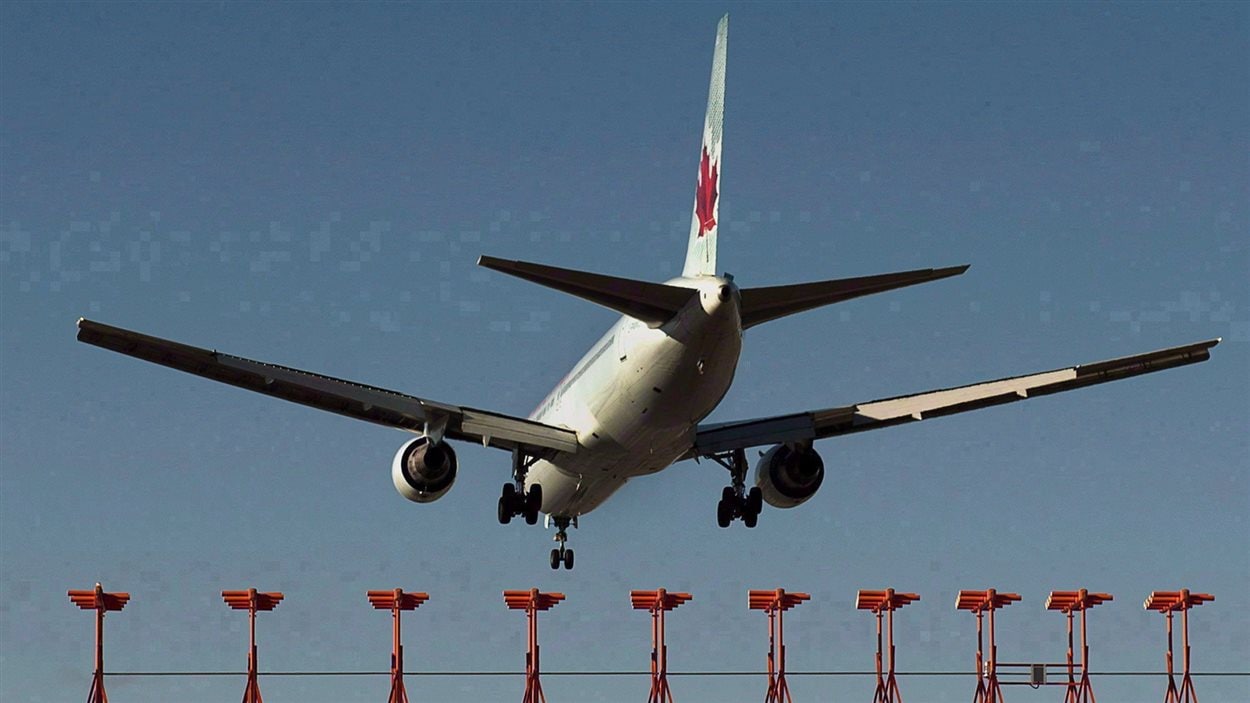 An Air Canada passenger jet is shown landing at Halifax Stanfield International Airport in Halifax on Jan. 21, 2013. A 47-year-old Alberta man has been charged after an incident on board an Air Canada flight en route to India was diverted back to Toronto early Wednesday morning. 