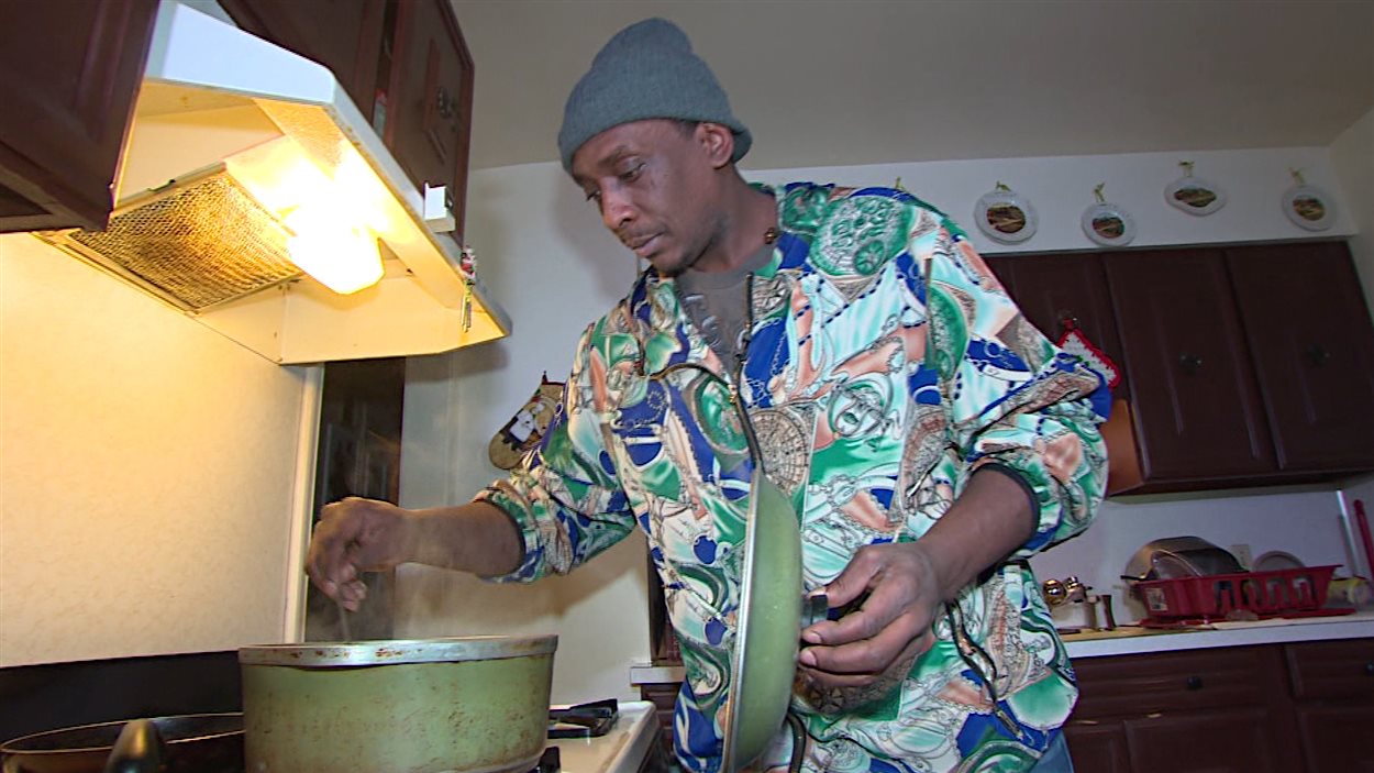 Dion McKinley, résident de Flint, prépare un repas avec de l'eau embouteillée.