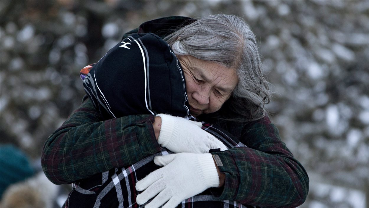 Des résidents de La Loche se consolent après la tragédie