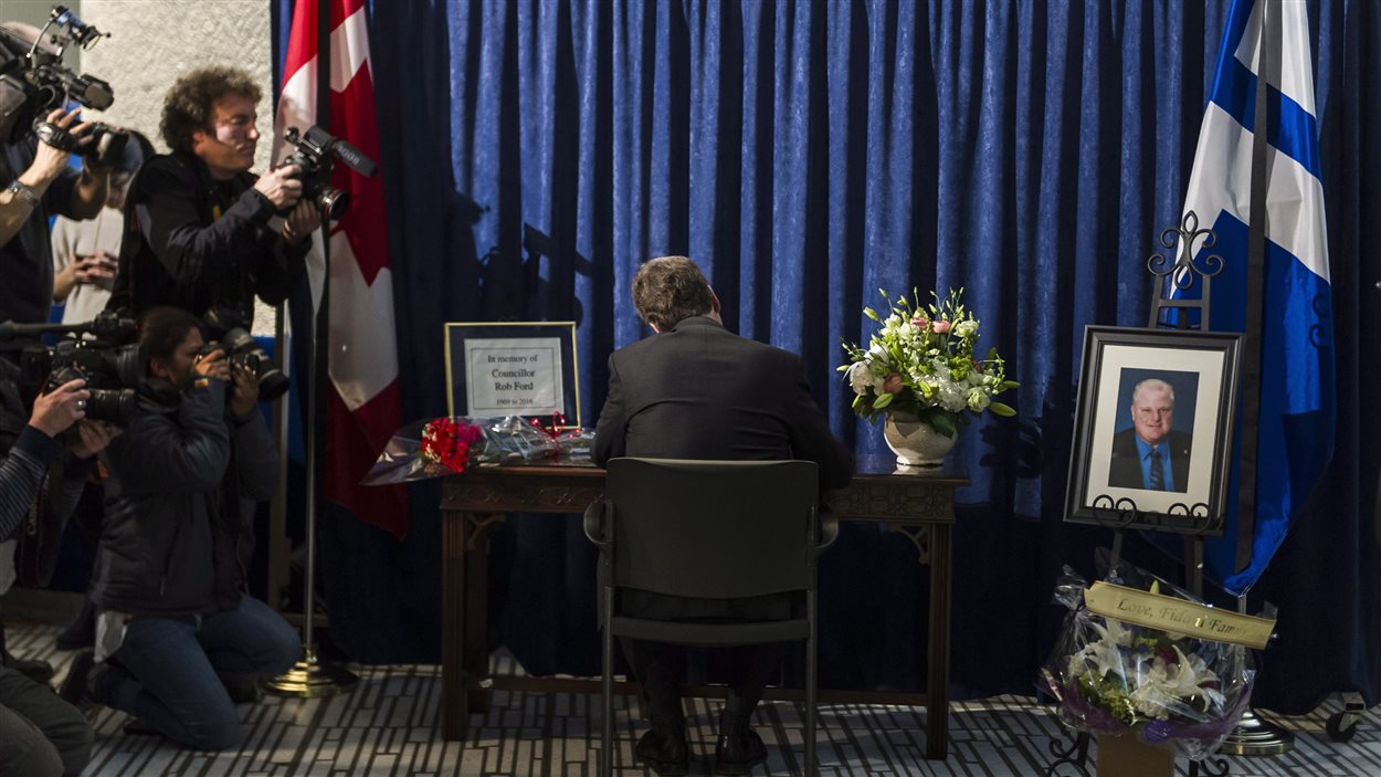 Le maire de Toronto, John Tory, signe le livre de condoléances pour Rob Ford à l'hôtel de ville.