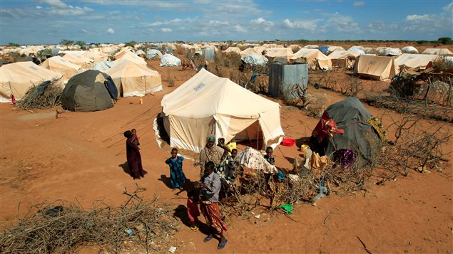  Refugees stand outside their tent at the Ifo Extension refugee camp in Dadaab, near the Kenya-Somalia border in Garissa County, Kenya October 19, 2011.