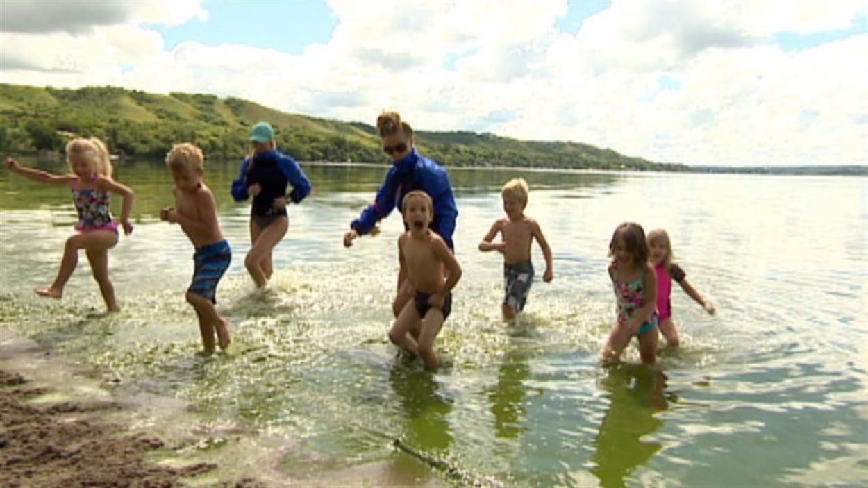 Des enfants se baignent dans un lac.