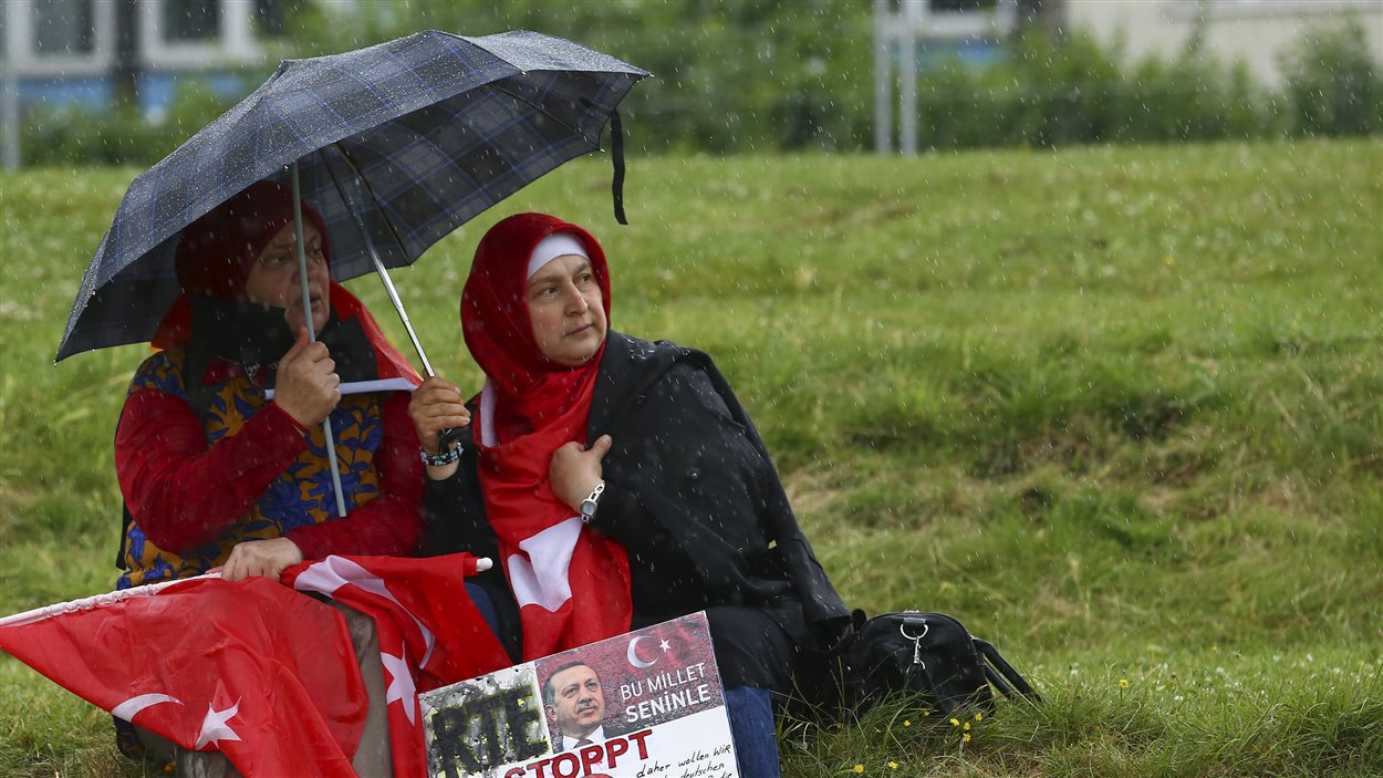 Deux manifestantes assises dans un champ durant la manifestation pro-Erdogan à Cologne en Allemagne