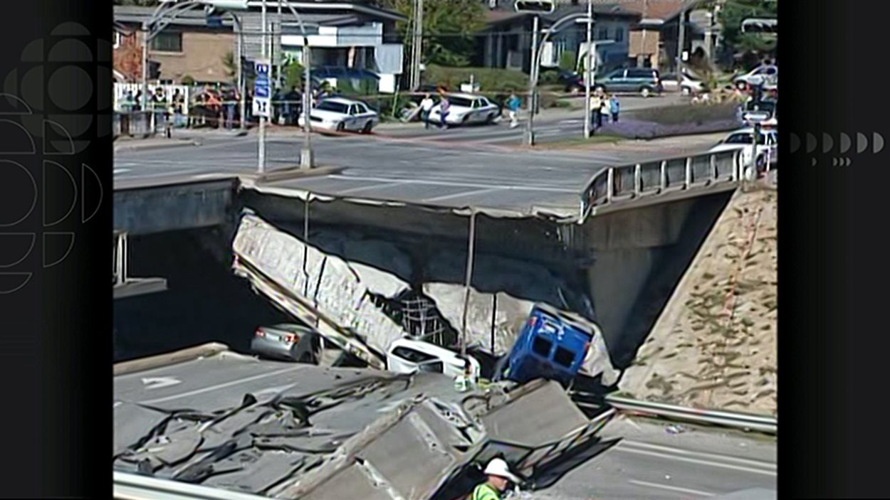 Plusieurs véhicules, dont une camionnette bleue, sous les décombres du viaduc de la Concorde