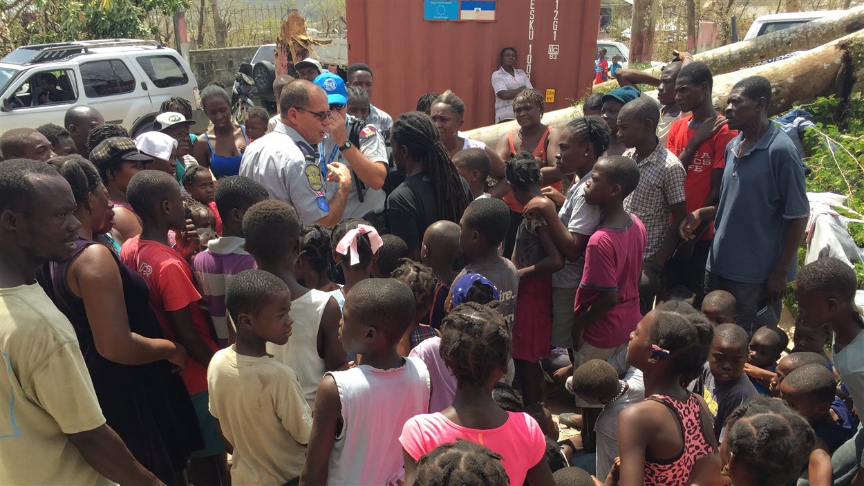 L'agent de la Sûreté du Québec Claude Desjardins, entouré d'enfants à Camp-Perrin, dans le sud d'Haïti